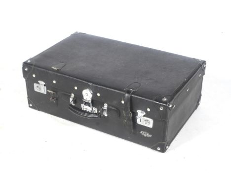 A large black suitcase in the Long March trunk style. With a single black leather handle and chrome studs and locks, H26cm x 