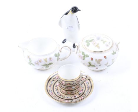 Four pieces of 20th century ceramics. Comprising a model of Poole penguin, H13.5cm, a Wedgwood teacup and saucer in the 'Clio