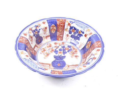 A 20th century Chinese ceramic basin. With blue and red painted floral decoration, unmarked. Diameter 34cm