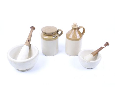 Two vintage pestle and mortars with two stoneware items. Including pestle stamped 'No. 3, 30'; the larger stamped '6, 27, 9';