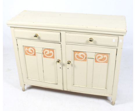 An Edwardian Art Noveau dresser base. Painted cream with orange details, the two short drawers positioned over a pair of pane