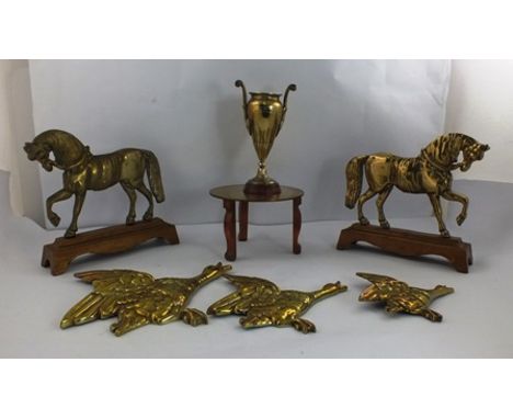 A GRADUATED SET OF THREE ART DECO CAST BRASS FLYING DUCKS with a 19th Century brass URN on marble socle, a circular brass TRI