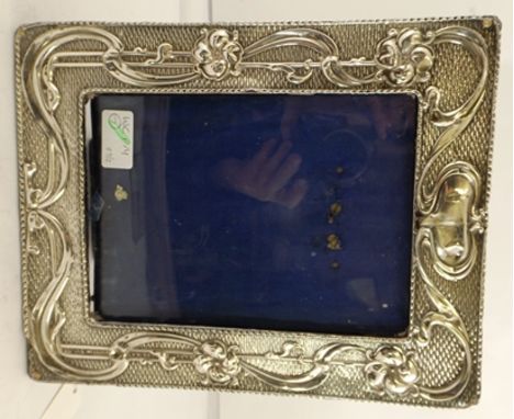 WILLIAM NEALE LTD AN EDWARDIAN ART NOUVEAU SILVER MOUNTED EASEL FORM PHOTOGRAPH FRAME embossed floral and tendril design, blu