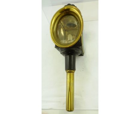 A PATENT CARRIAGE LANTERN painted metal and brass with clear and red lenses, sprung light mechanism, circa 1900, 46cm high 