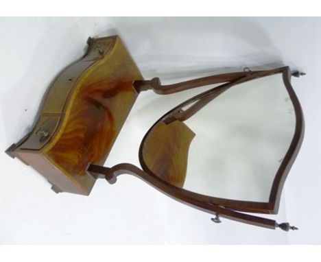 A REGENCY DESIGN MAHOGANY SERPENTINE BOX BASE TOILET MIRROR with shield shaped plate, base fitted three drawers raised on oge
