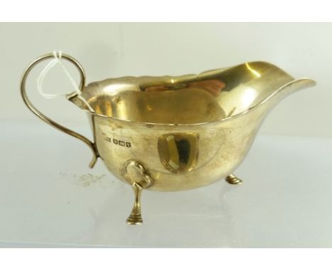 MAPPIN & WEBB AN EDWARDIAN CHIPPENDALE STYLE SILVER SAUCE BOAT having cut shaped rim, raised on three paw feet, London 1904, 