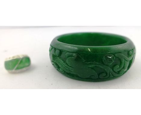 A CARVED SPINACH JADE BANGLE (inner dimension 6cm) and a SILVER JADE SET RING 