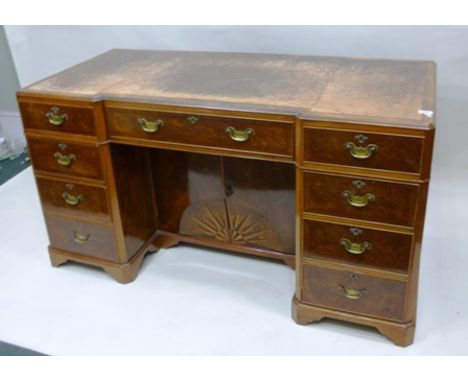 A MID 20TH CENTURY WALNUT VENEERED DOUBLE PEDESTAL DESK having leather inset top with inverted front over an arrangement of n