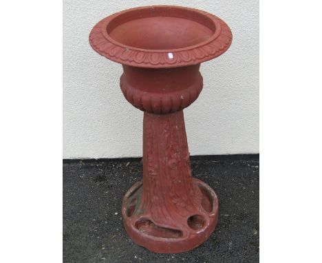 A large moulded terracotta planter jardiniere / planter on stand, the urn with flared egg and dart rim above a moulded simula