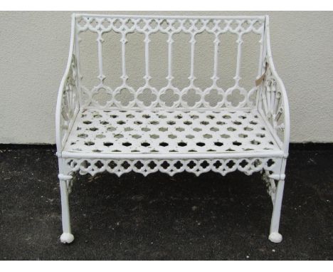 A small cream painted cast alloy two seat garden bench with pierced gothic tracery detail, 87 cm, wide 