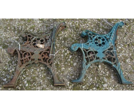 Two pairs of matching cast iron bench ends with pierced foliate and lions mask detail, 72 cm (full height) 