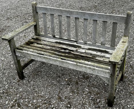 A weathered two seat garden bench with slatted seat and back (unmarked) but possibly a Lister example, 128 cm wide 