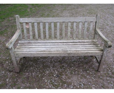 A weathered teak Tiger Trading three seat traditional garden bench with slatted seat and back, 153cm wide 