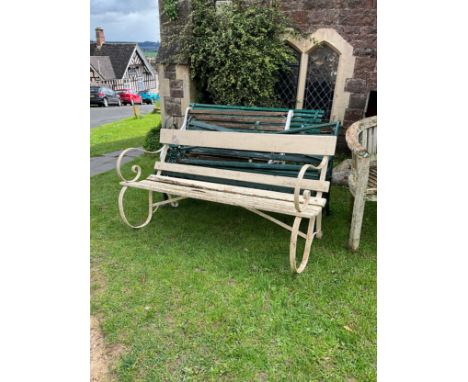 A 19th century painted and weathered garden bench, with painted wooden slats and sprung iron supports 