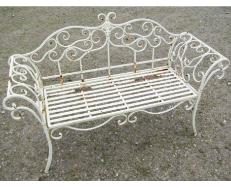 A contemporary weathered cream painted two seat garden bench loosely in the Regency style with swept and open scrolled detail