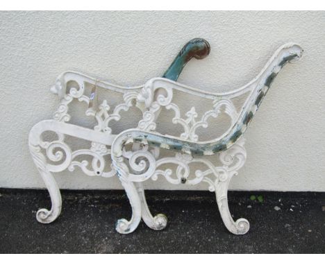 A pair of painted heavy gauge cast iron bench ends with scroll detail and lions mask terminals, 77 cm (full height) 
