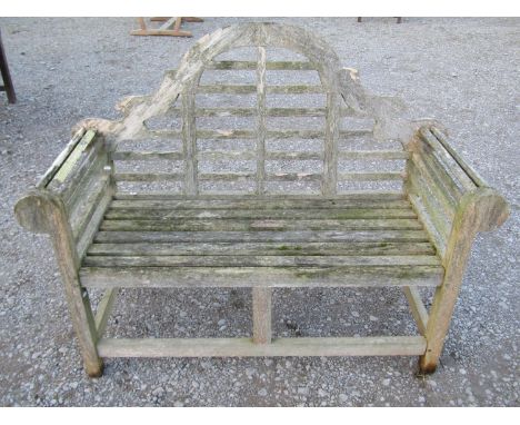 A weathered teak Lutyens style two seat garden bench, 136 cm wide 