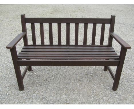 A Wrinch vintage stained teakwood two seat garden bench with slatted seat and back, 127 cm wide 