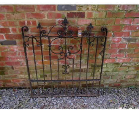 A heavy gauge iron gate with decorative open scroll work detail and spearhead finials, 121cm high x 112cm wide 