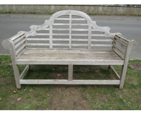 A weathered (silvered) teak Lutyens style three seat garden bench, 166 cm wide 