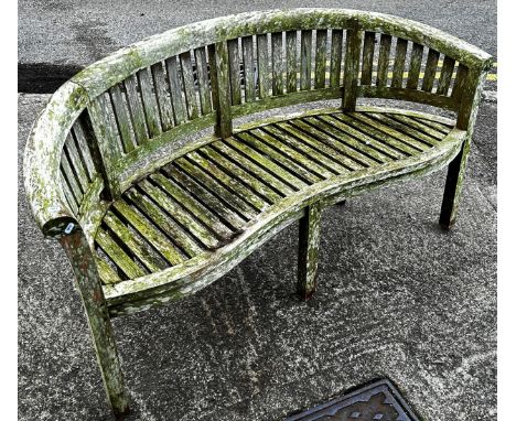 A Cotswold Collection weathered teak banana shaped garden bench (af) 160 cm 