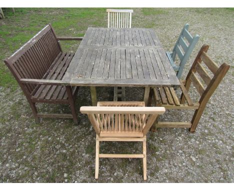 An associated suite of garden furniture comprising a weathered teak table with rectangular slatted panelled top 150 x 100 cm 