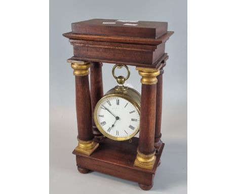 French brass pocket watch style mantle clock with ceramic enamel face, now displayed in a portico type clock frame of later m