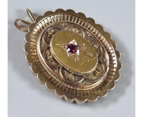 Victorian yellow metal mourning locket inset with small ruby stone. 11.4g approx. (B.P. 21% + VAT)