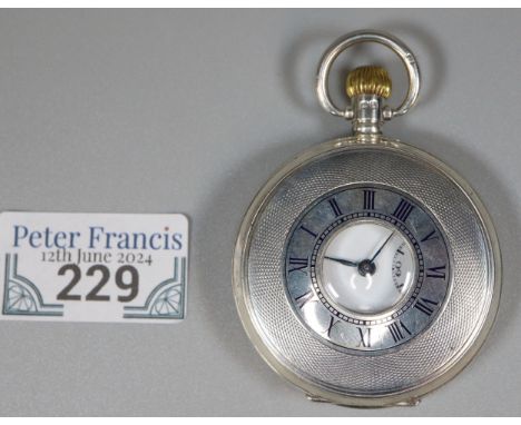 Benson silver half hunter keyless top wind pocket watch with Roman enamel face, having seconds dial and engine turned exterio