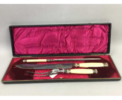 VICTORIAN CARVING SET,cased, along with four silver teaspoonsSome oxidisation and marks to the blades, light general surface 