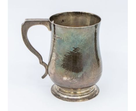 An Arts &amp; Crafts silver planished baluster mug, hallmarked Haseler Brothers, Chester, 1913, 5.58 ozt (173.6 grams) (dents