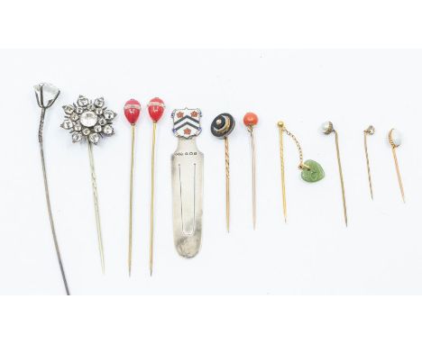 A collection of stick pins including late Georgian examples as well as opal and Art Deco, along with a silver hallmarked book