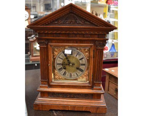A German mantel clock by R Schnenburger, contained on a walnut style case, with two train movement, chiming on two gongs, ser