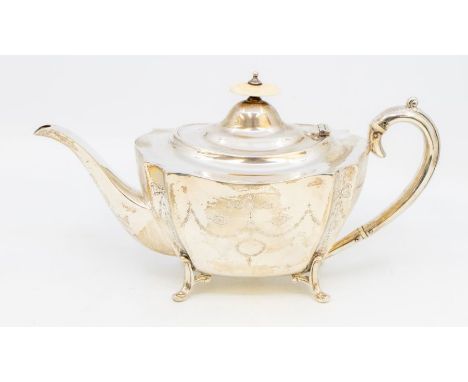 A George V shaped silver teapot, the body engraved with Neo-Classical decoration, on four scroll feet, C-scroll handled, pago