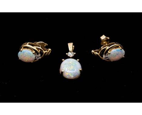 An opal and diamond gold pendant, comprising a claw set oval opal approx 9 x 11mm, to a claw set diamond approx 0.10ct, lengt