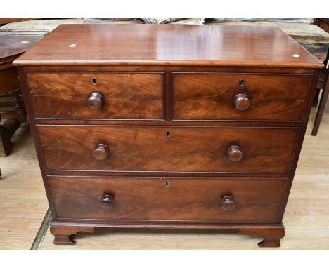 An early 19th Century mahogany chest of two above two drawers with knob handles on bracket feet