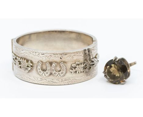 A Victorian silver hinged bangle decorated with horseshoes and fauna, width approx 25mm, along with a white metal modernist r