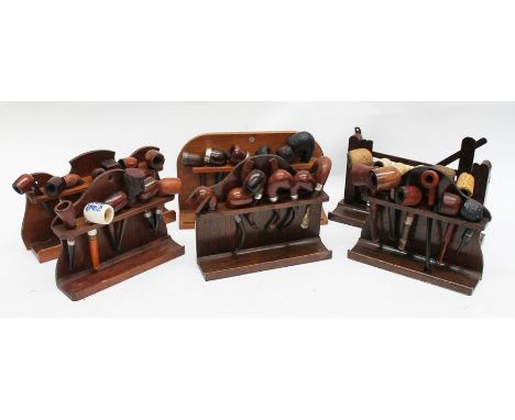 Six oak pipe racks with pipes