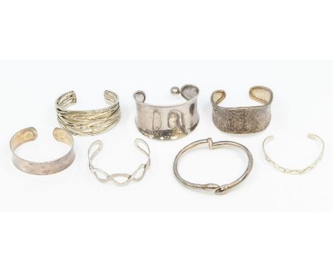 A collection of five silver cuff bangles various styles and widths, marked 925, total gross weight approx 140gms, along with 