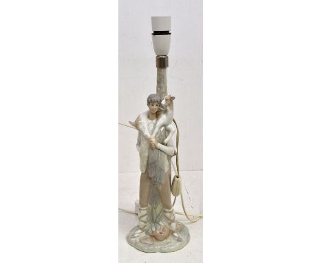 A group of Lladro to include: elongated Man with Kid goat lamp, stamped to base with shade; another smaller table lamp of Pra
