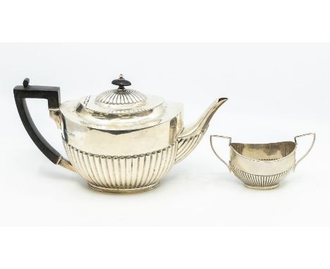 A Georgian style oval silver gadrooned teapot, ebonised handle &amp; finial, hallmarked by William Hutton &amp; Sons., London