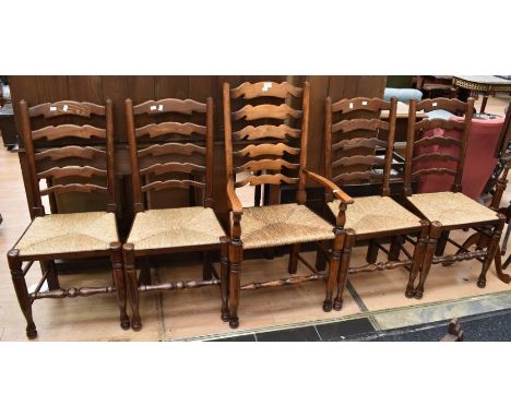 A set of five ladder-back chairs in oak including one carver in the 19th Century style