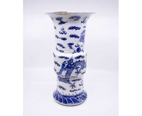 A Chinese blue and white Gu shaped dragon vase, Qing Dynasty, late 19th century, painted with four claw dragons amongst cloud