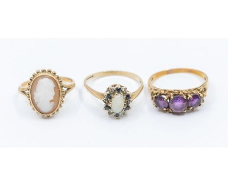 A collection of three of 9ct gold rings including a three stone amethyst, size S1/2,  sapphire and opal cluster, size T and a