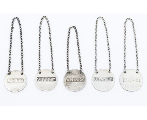 A matched set of five early 20th Century silver circular bottle labels, on suspension chains, all hallmarked by Sampson Morda