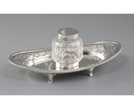 A Victorian silver and cut glass inkstand, by Haseler & Bill, hallmarked for London 1899, of pierced oval form with gadrooned