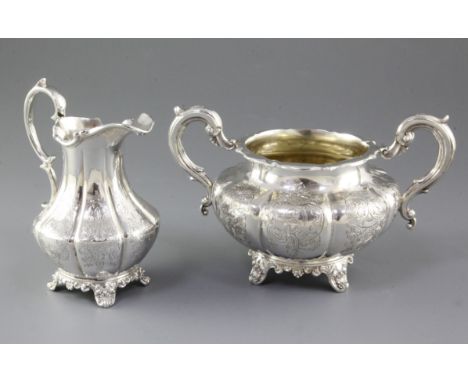 An early Victorian silver sugar basin and tall cream jug, by William Hunter, hallmarked London 1852, each of bulbous form wit