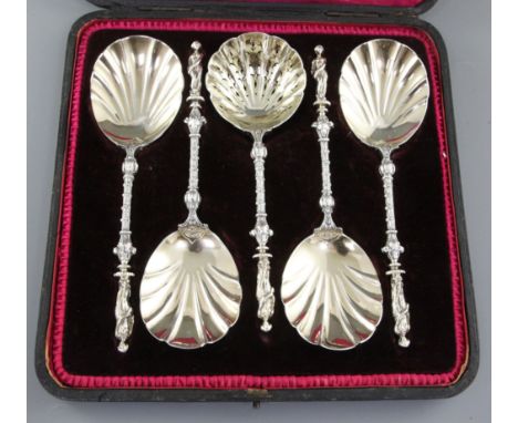 A cased set of four Victorian silver parcel gilt fruit serving spoons and a sugar sifter, hallmarked London 1897, Charles Stu