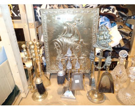 Three fireside companion sets and brass fireguard with ship detail 