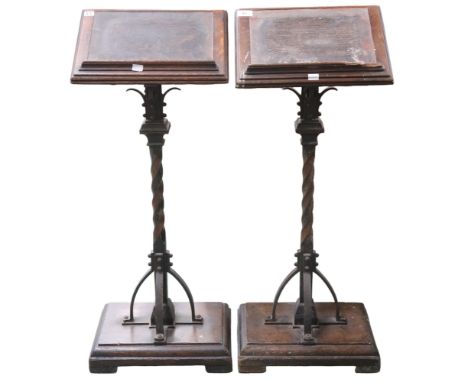 A pair of Victorian ecclesiastical style lecterns with oak book slopes on twisted wrought iron uprights on oak plinth base, 9